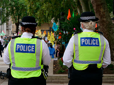 Two police officers with their backs facing the camera